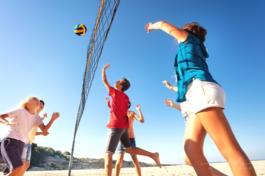 teens playing sand volleyball
