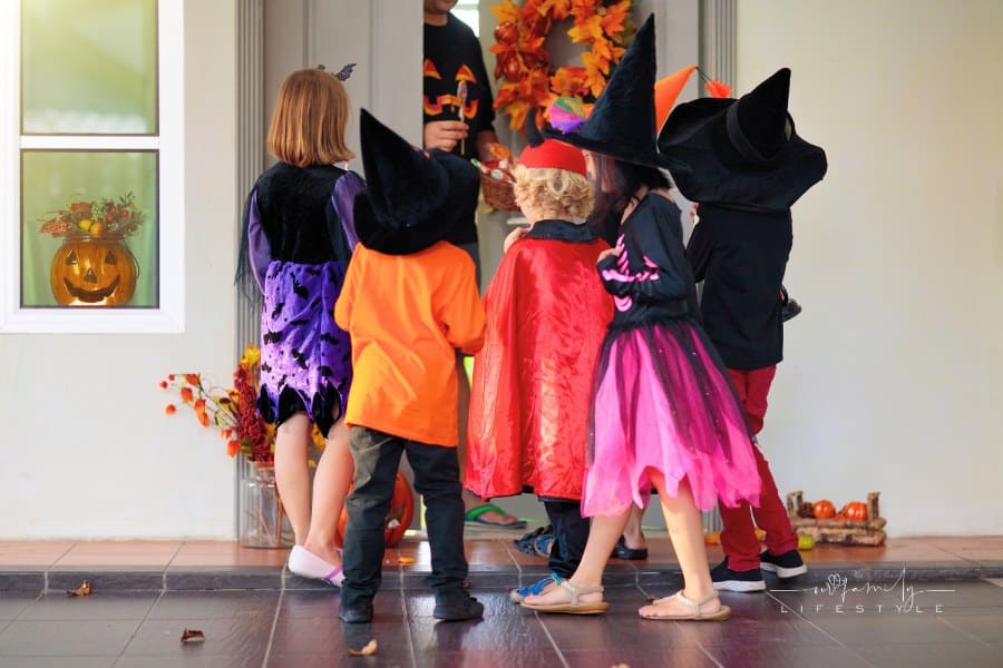 Kids trick or treat. Halloween. Children at door.