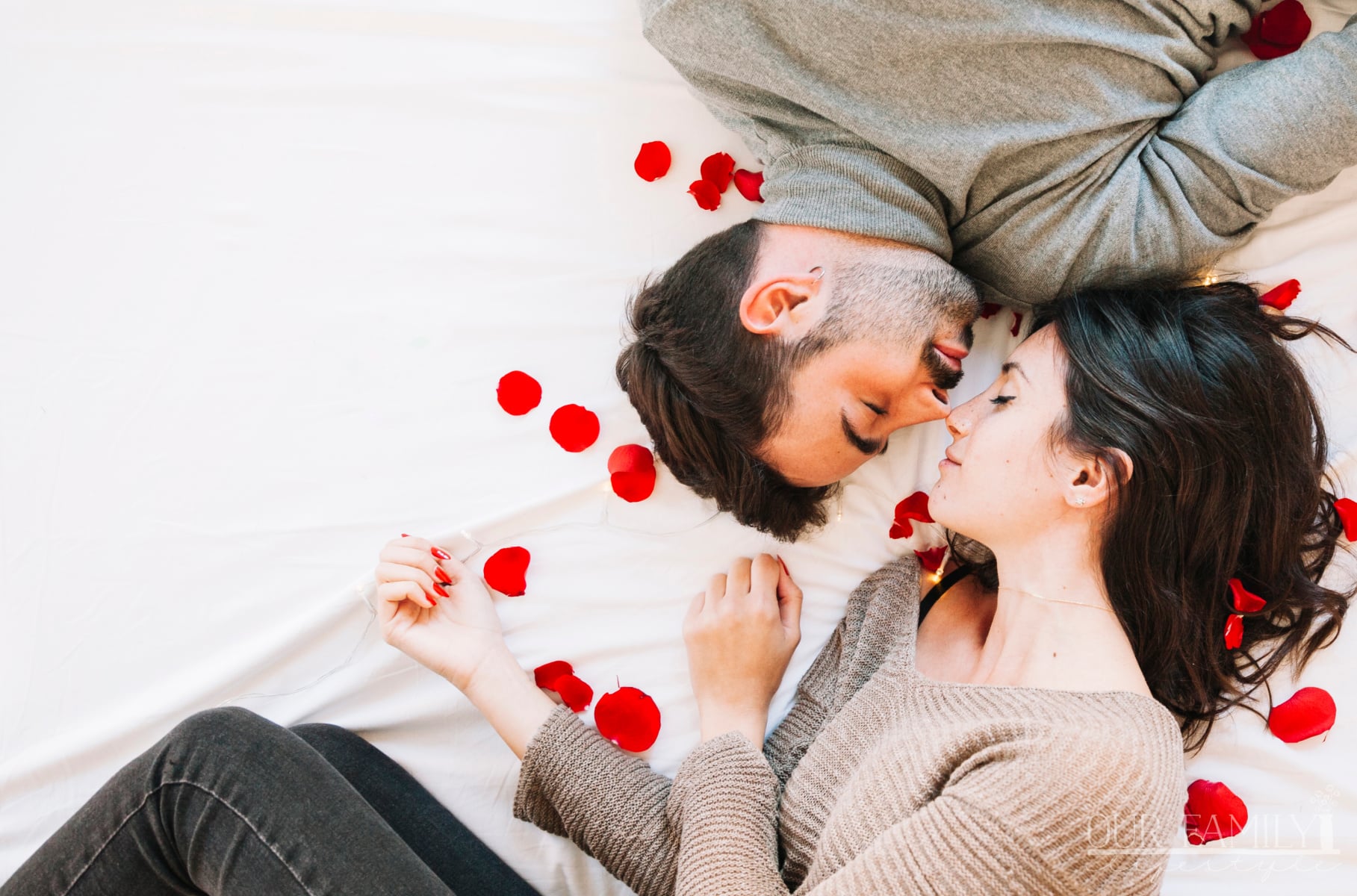 couple on bed of rose petals