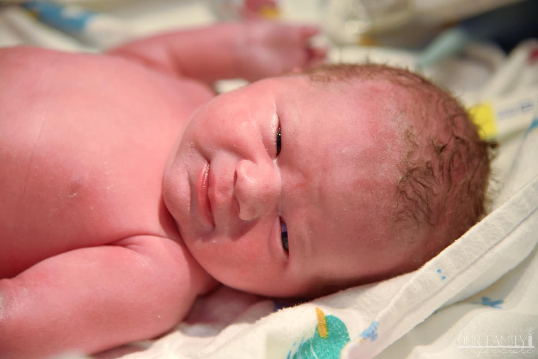 newborn baby girl looking at camera