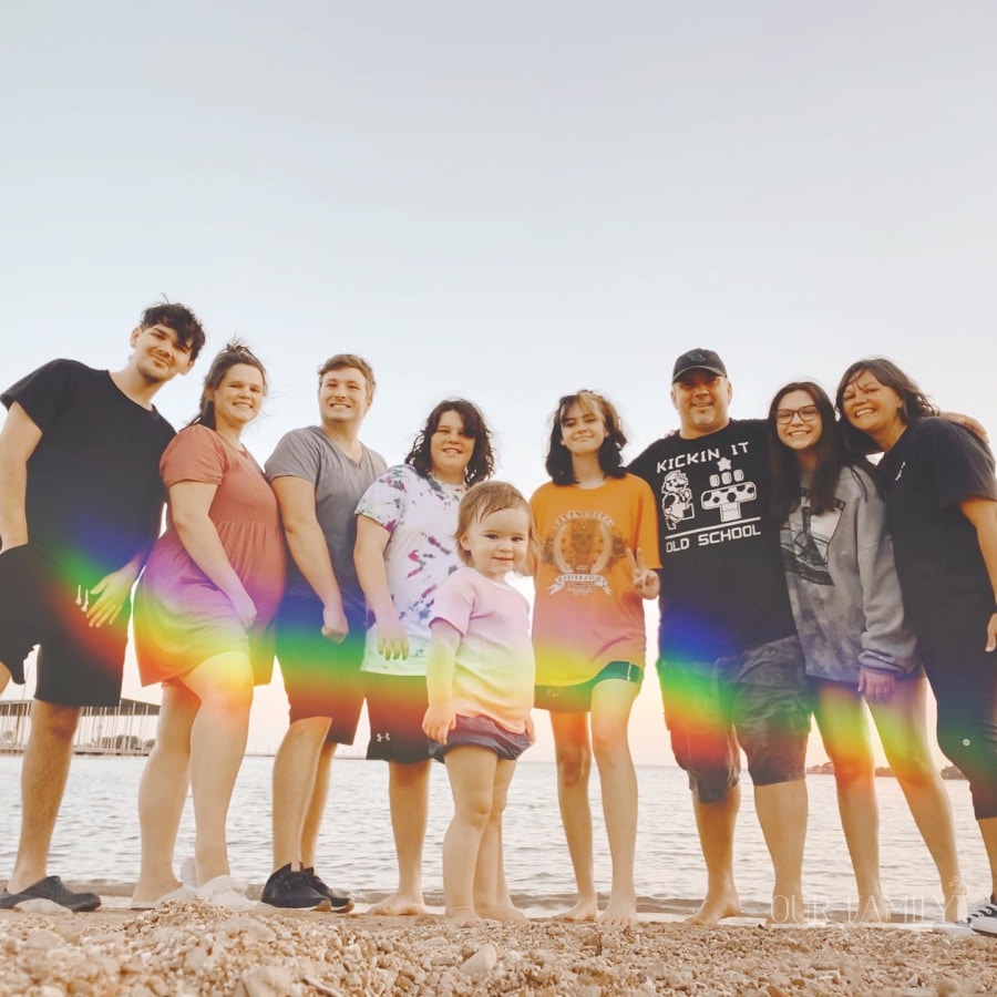 rainbow wave over family at lake